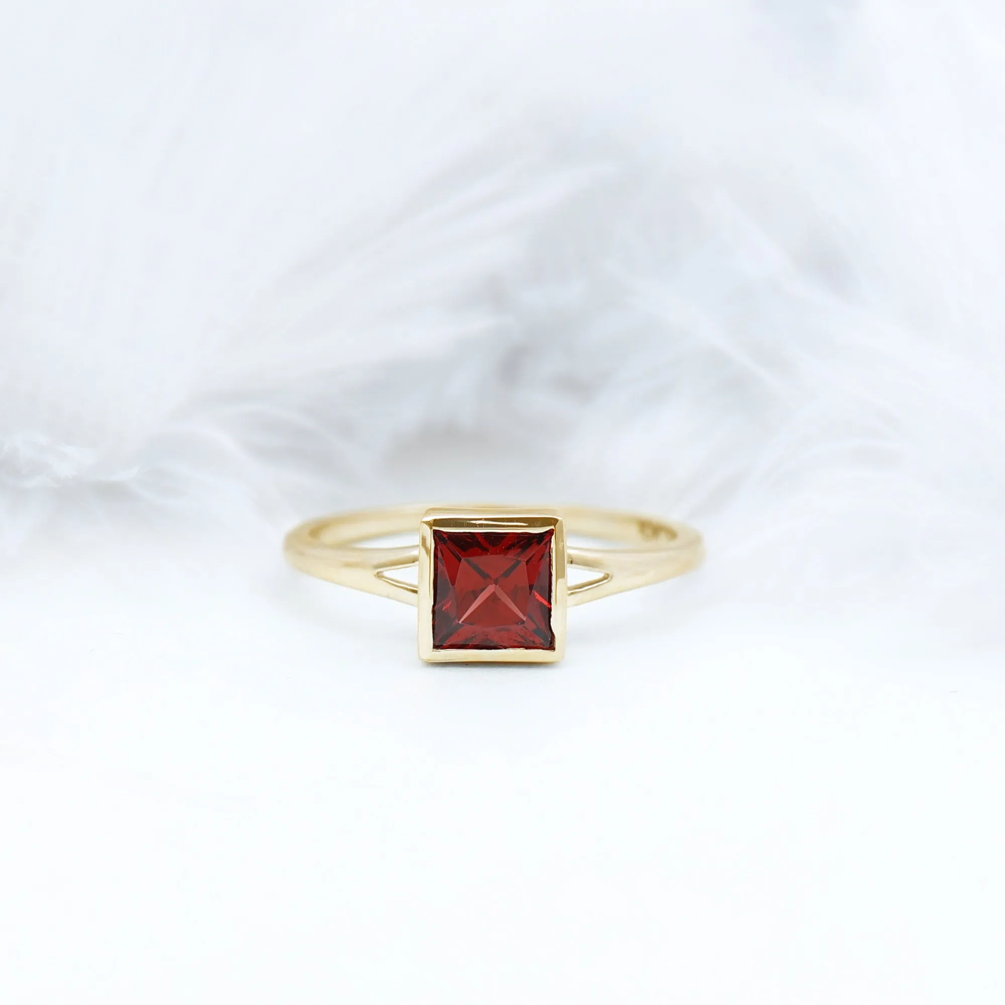 Princess Cut Garnet Solitaire Split Shank Ring in Bezel Setting